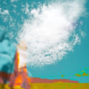 Abstract desert scene with a towering, blurred sandstone form rising from a green and ochre plain beneath a teal sky, featuring a bright white cloud that dominates the upper portion of the composition.