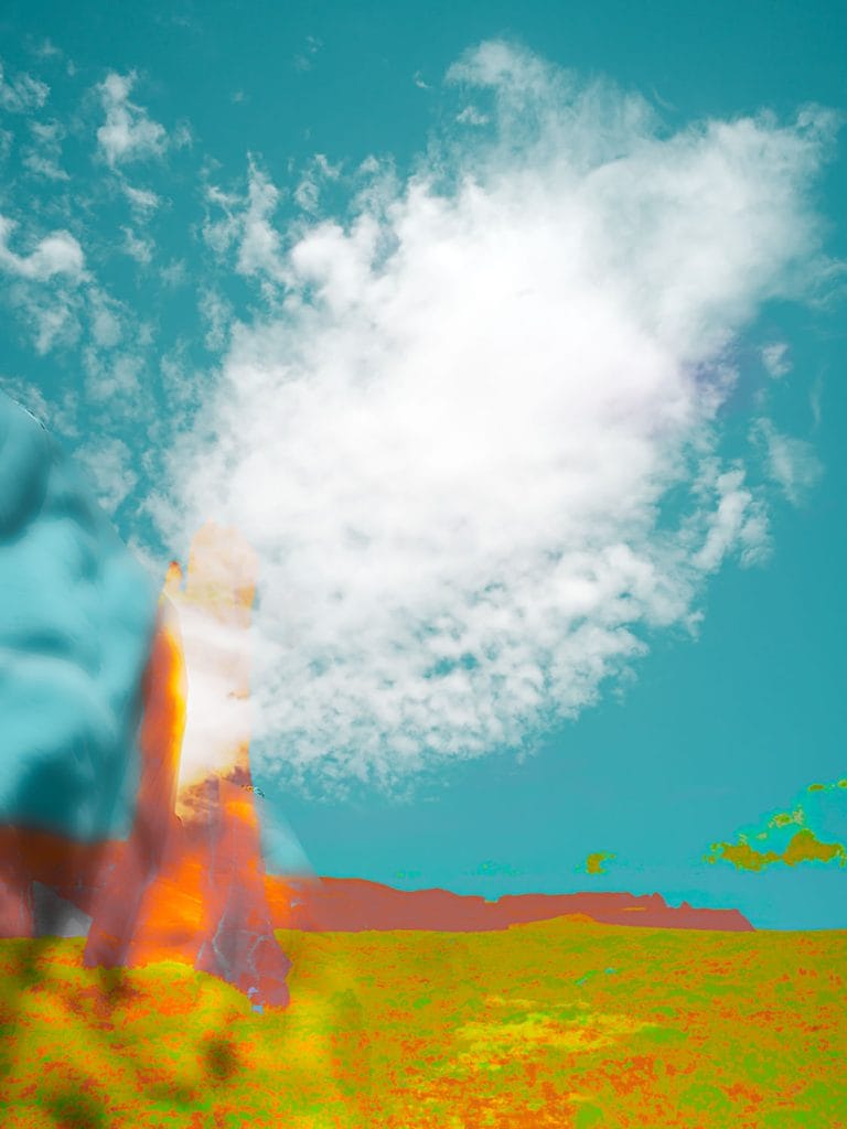 Abstract desert scene with a towering, blurred sandstone form rising from a green and ochre plain beneath a teal sky, featuring a bright white cloud that dominates the upper portion of the composition.